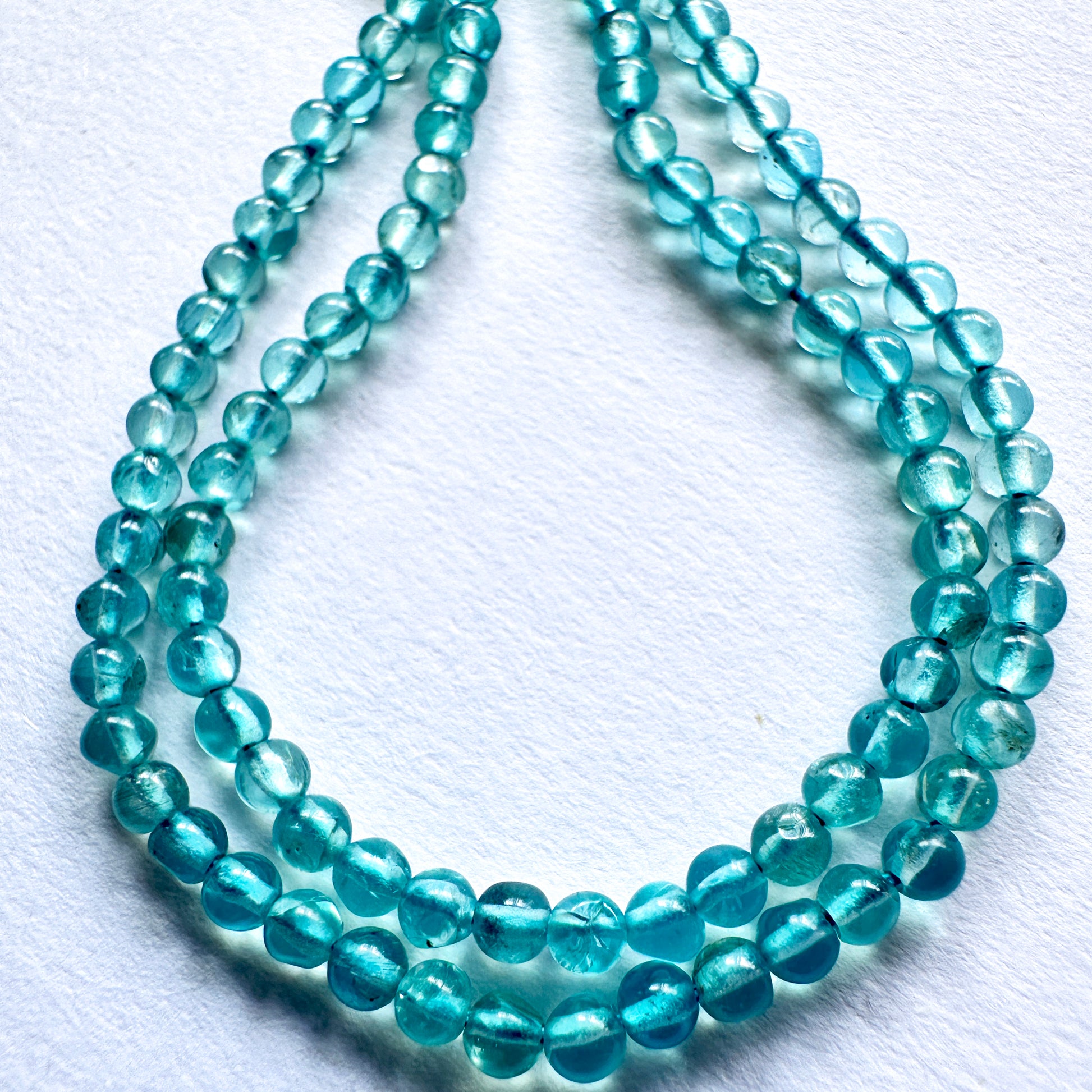 Handmade jewellery components featuring polished Green Apatite beads with 0.4mm drilled holes.