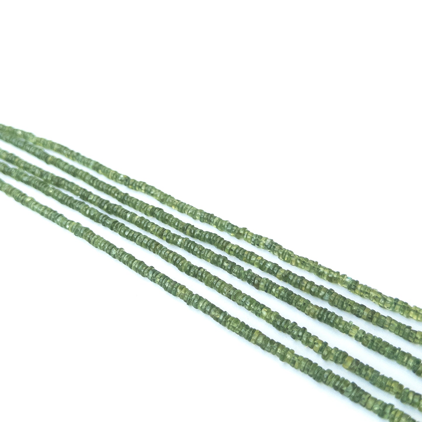 Handmade jewellery components featuring natural green apatite smooth wheel beads in a neatly aligned strand.