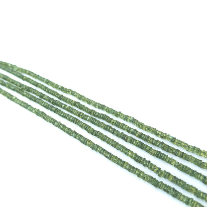 Handmade jewellery components featuring natural green apatite smooth wheel beads in a neatly aligned strand.