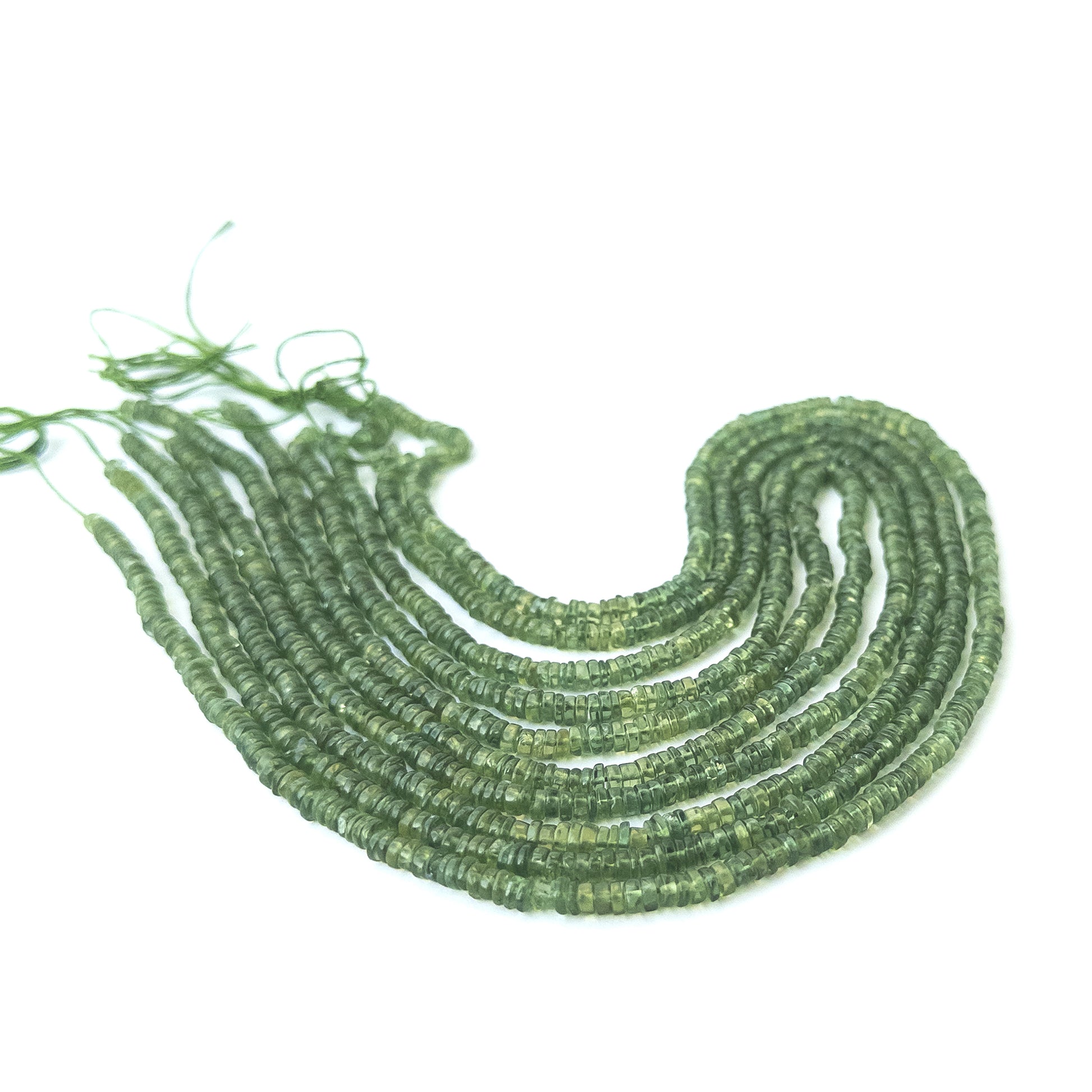 Green apatite smooth wheel gemstone beads in 4mm size arranged on a 41cm strand for jewellery making.