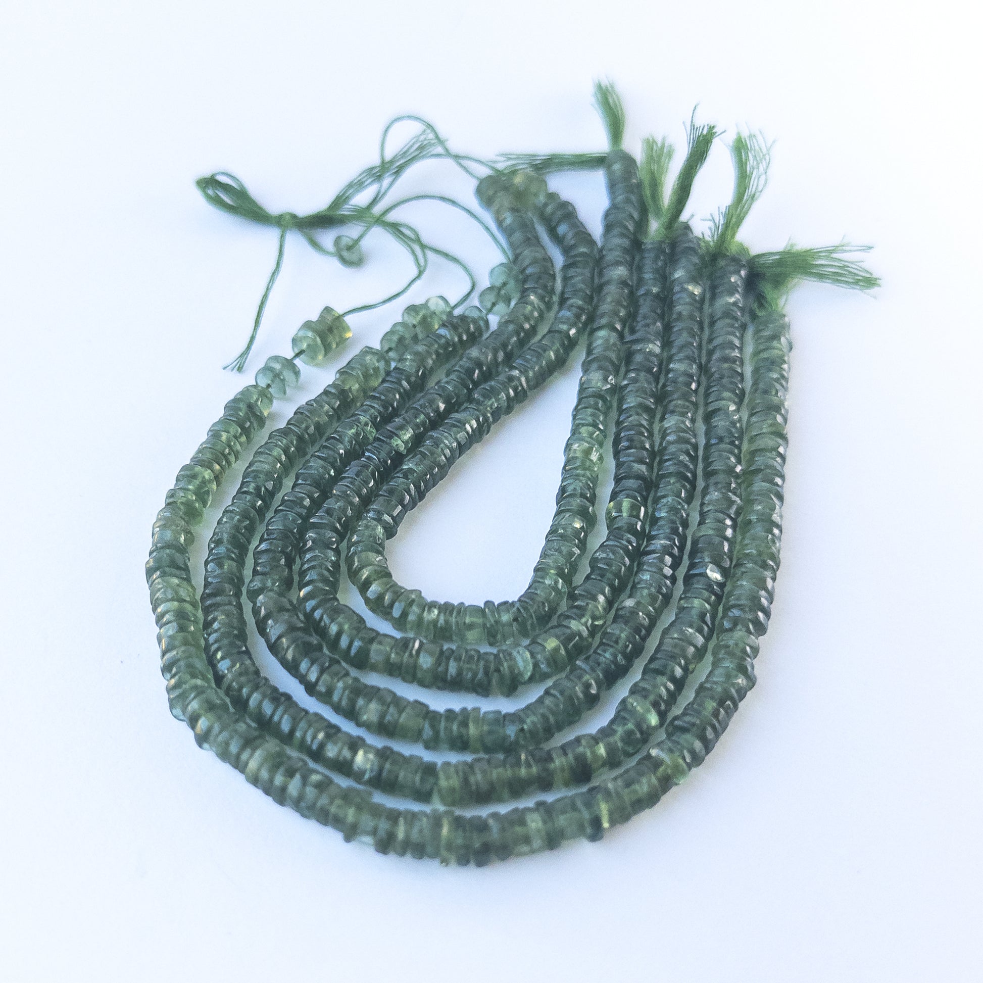 Authentic Green Apatite gemstone beads showcasing lively colour, smooth wheel shaping and premium bead quality for jewellery designers.
