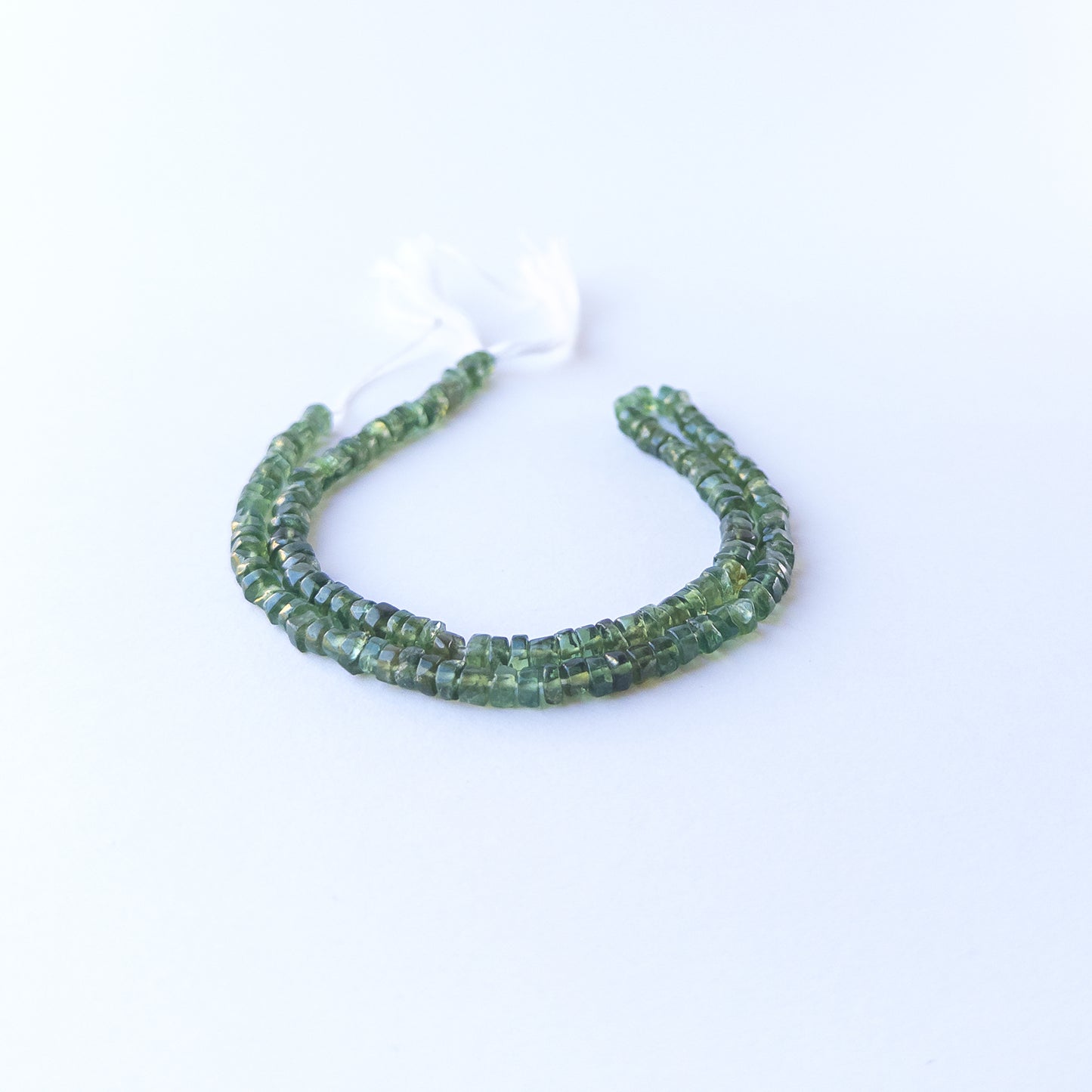 Green Apatite smooth wheel stone beads with uniform 4.5–4.6mm size and bright natural green tone.