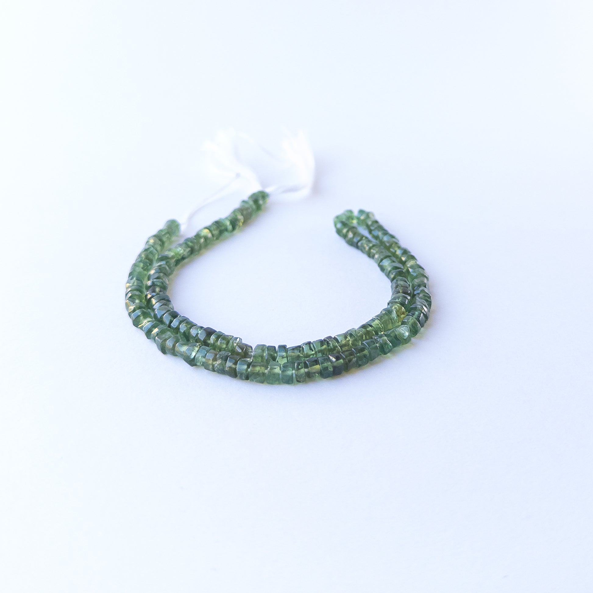 Green Apatite smooth wheel stone beads with uniform 4.5–4.6mm size and bright natural green tone.