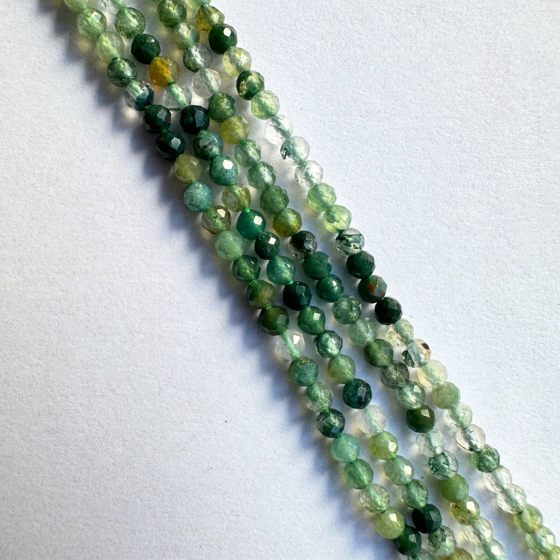 Natural green aventurine beads in rondelle shape, displaying consistent size and polished finish.