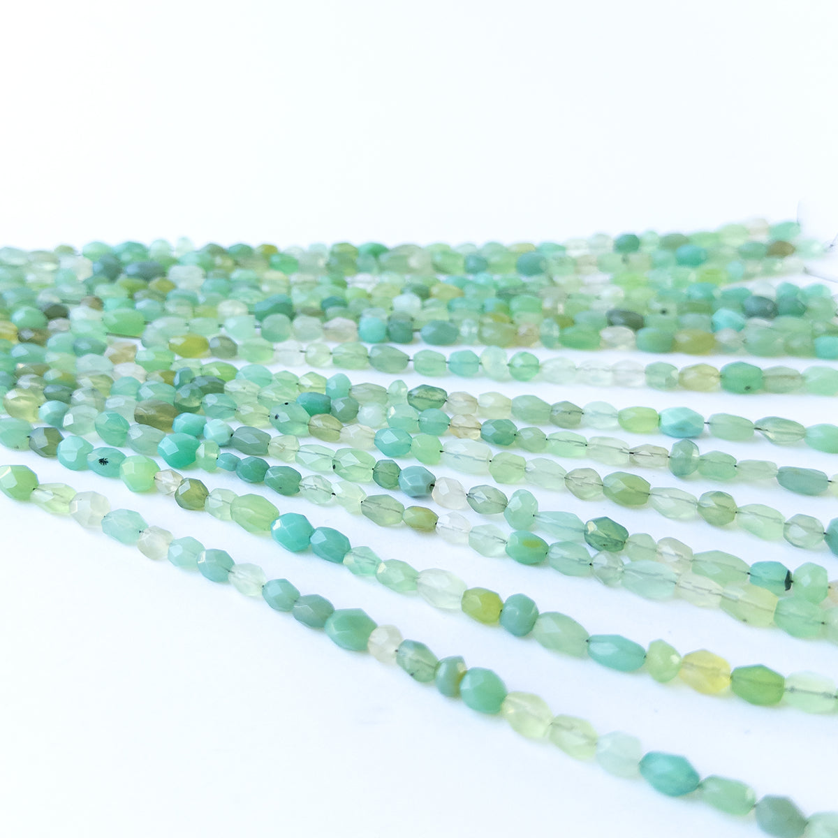 Authentic Green Chalcedony gemstone beads displaying polished facets and natural green colour.