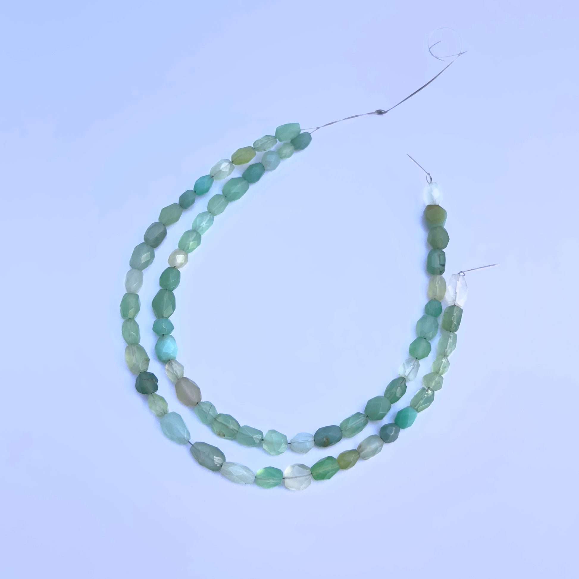 Green Chalcedony faceted oval beads in refreshing green tones strung on a 21cm strand.