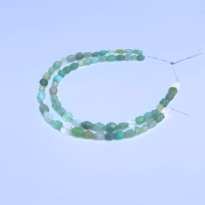 Natural Green Chalcedony stone beads arranged in strands with luminous green hues.