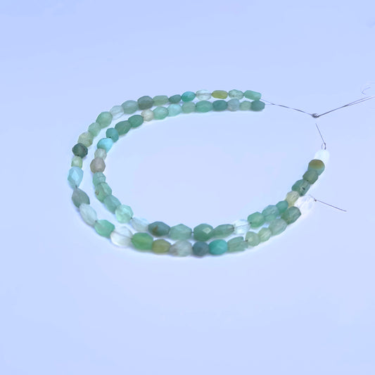 Natural Green Chalcedony stone beads arranged in strands with luminous green hues.