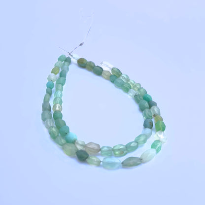 Green Chalcedony gemstone beads for jewellery making displayed with soft lighting.