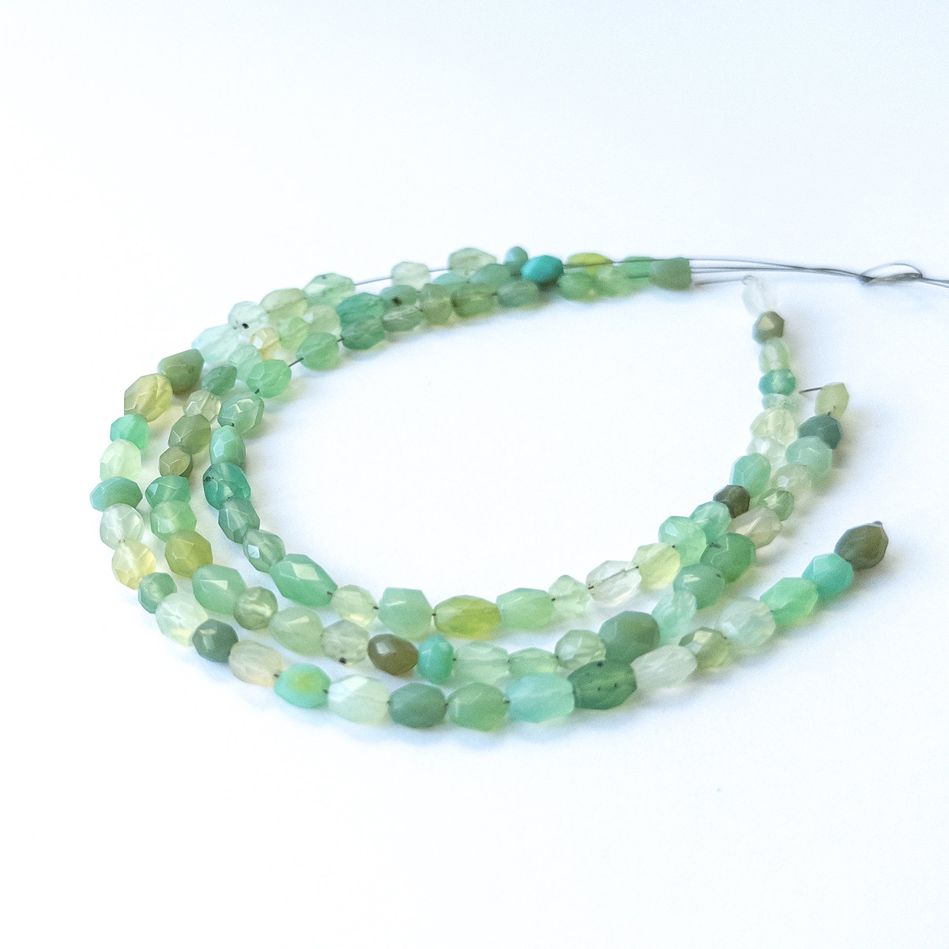Natural Green Chalcedony stone beads with polished faceted oval shapes, perfect for artisan jewellery components.