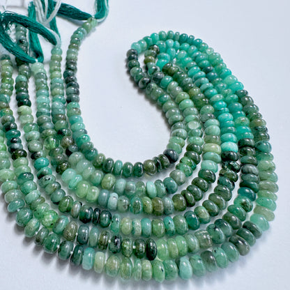 Delicate strands of Green Emerald beads, showcasing their smooth design.