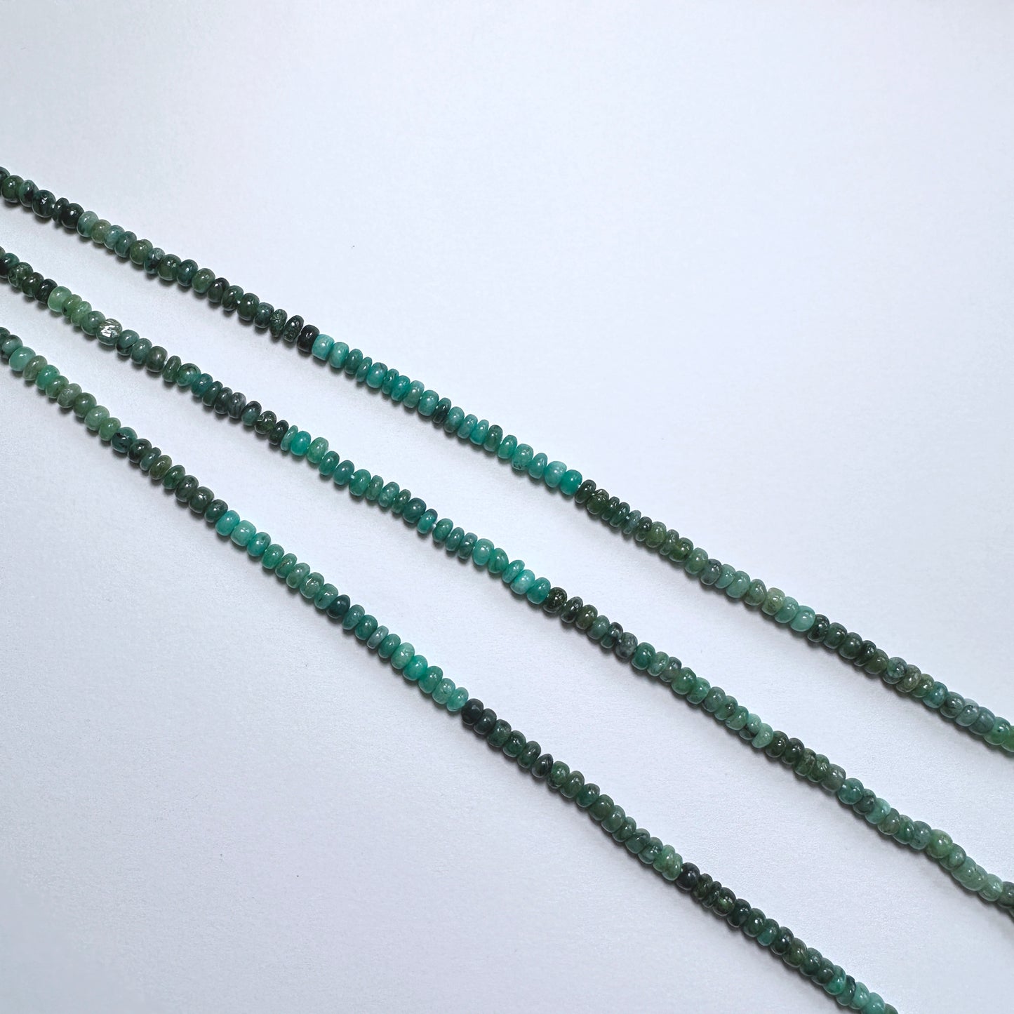 Australian gemstone bead supplier showcasing Green Emerald rondelle beads with 0.5mm drill holes.