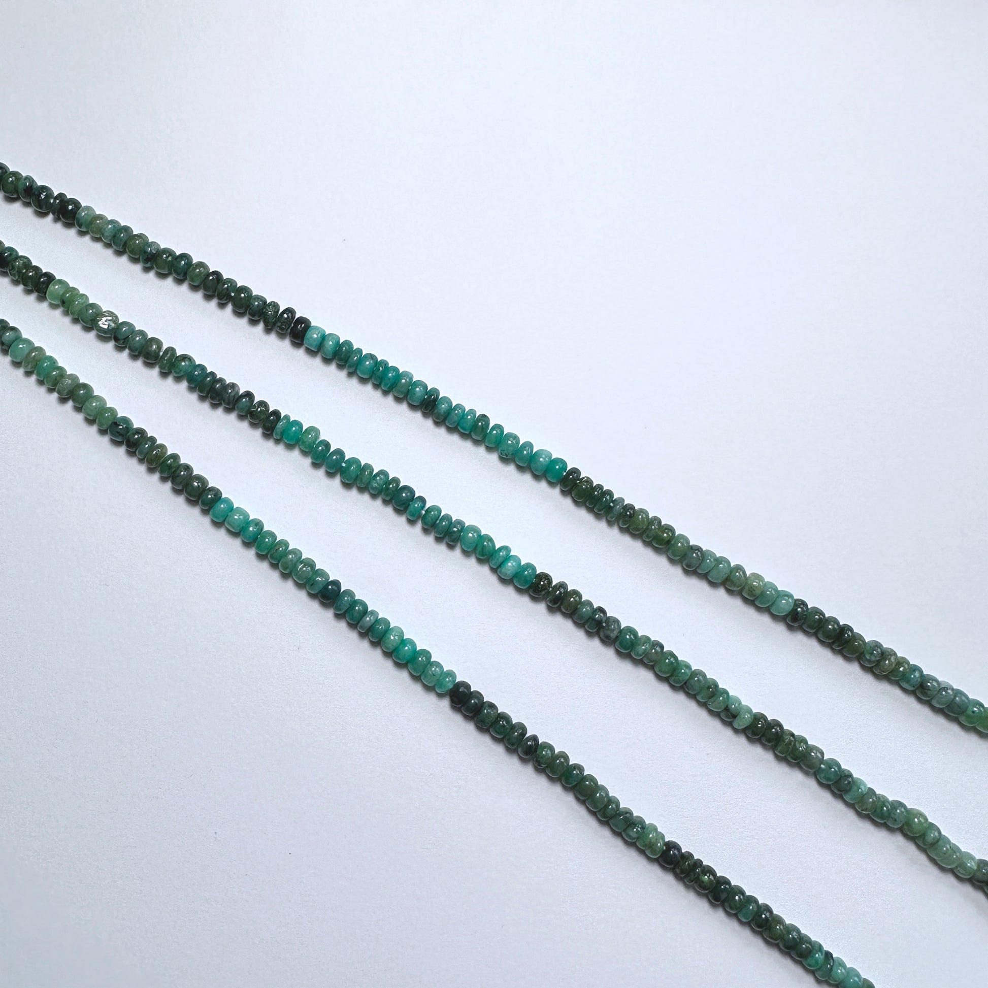 Australian gemstone bead supplier showcasing Green Emerald rondelle beads with 0.5mm drill holes.