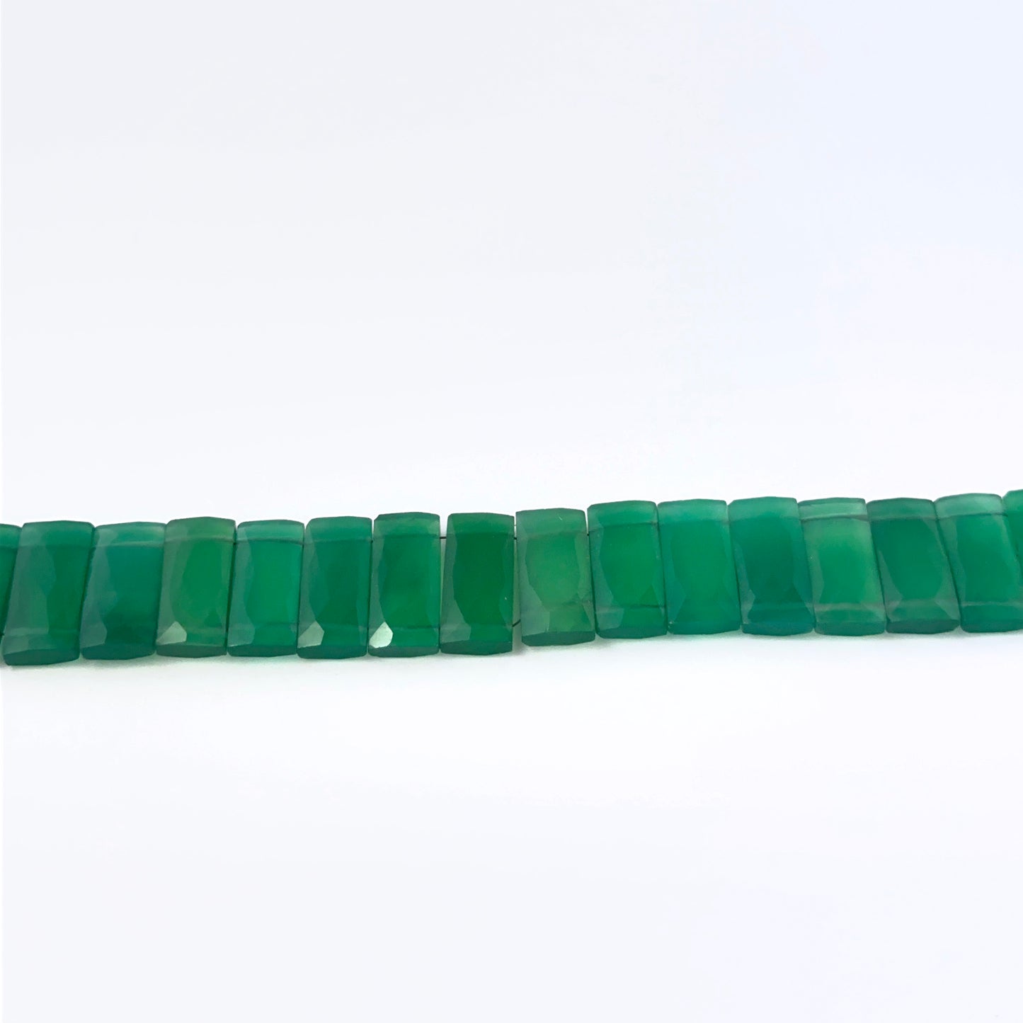 Close view of Green Onyx faceted rectangle stone beads showing cut, clarity and shimmer for DIY jewellery makers.