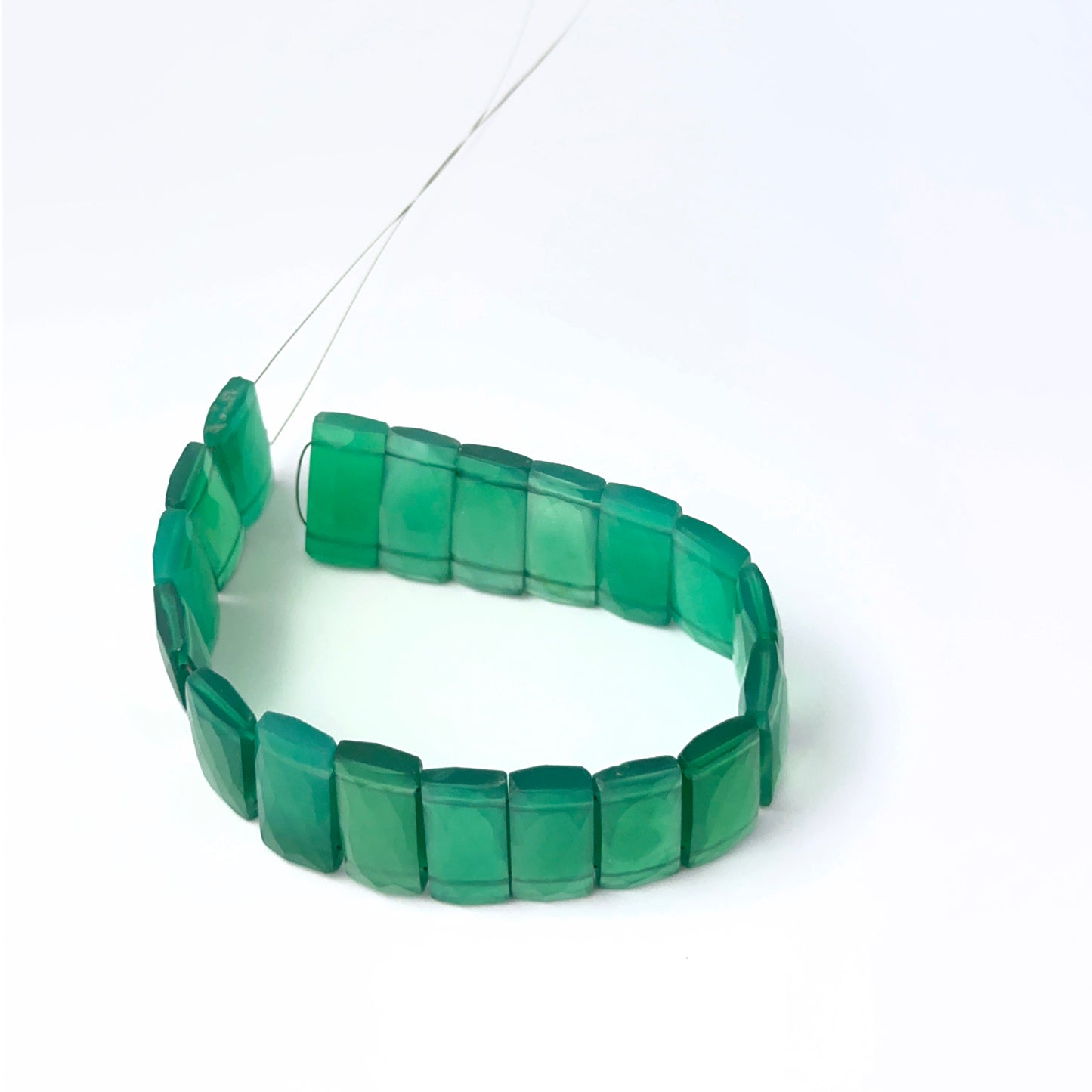 Faceted rectangle Green Onyx stone beads arranged neatly, highlighting their polished finish and handmade jewellery component quality.