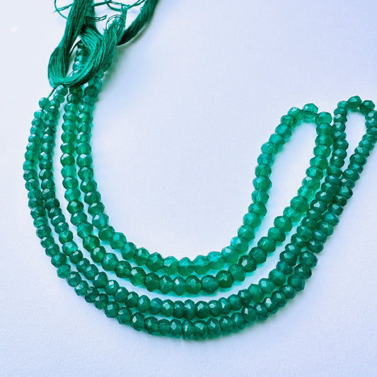 Green onyx stone beads with faceted rondelle cut and vibrant green tones for elegant handmade jewellery components.
