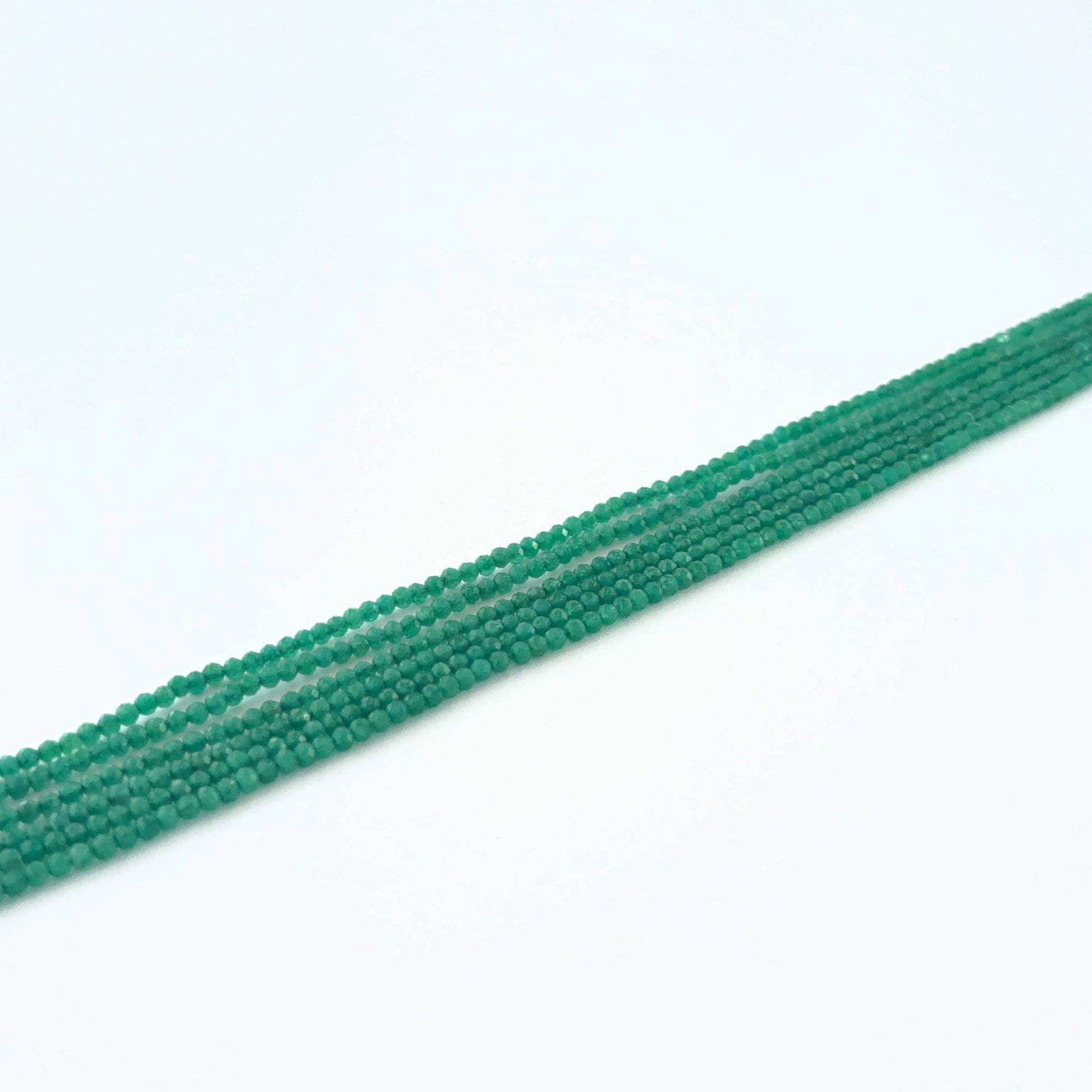 Green Onyx micro‑faceted rondelle beads showing bright green colour and crisp sparkle