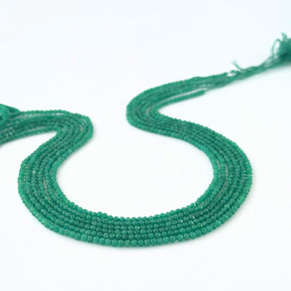 Micro‑faceted Green Onyx rondelle beads arranged neatly, highlighting their polished finish and handmade jewellery component quality.