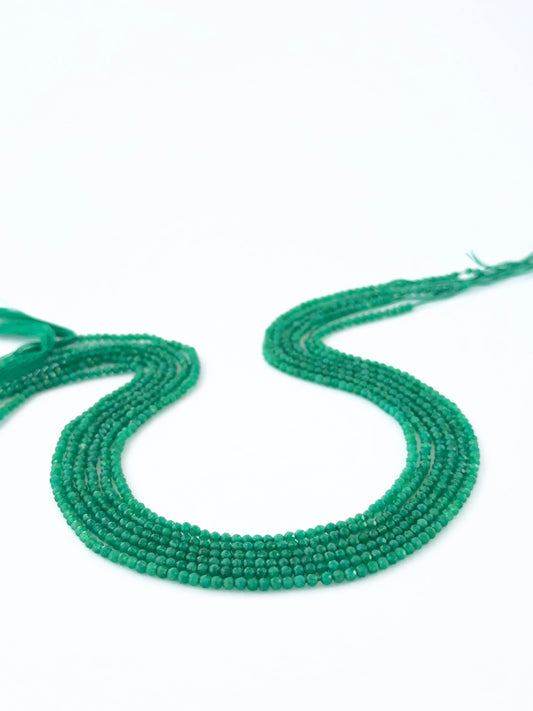 Close view of Green Onyx micro‑faceted rondelle beads showing cut, clarity and premium gemstone quality