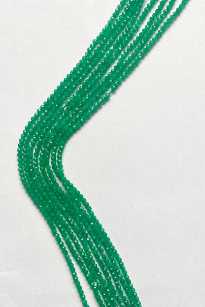 Vibrant Green Onyx micro-faceted rondelle beads, 2.4mm, elegantly arranged on a 32cm strand.