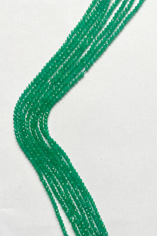 Vibrant Green Onyx micro-faceted rondelle beads, 2.4mm, elegantly arranged on a 32cm strand.