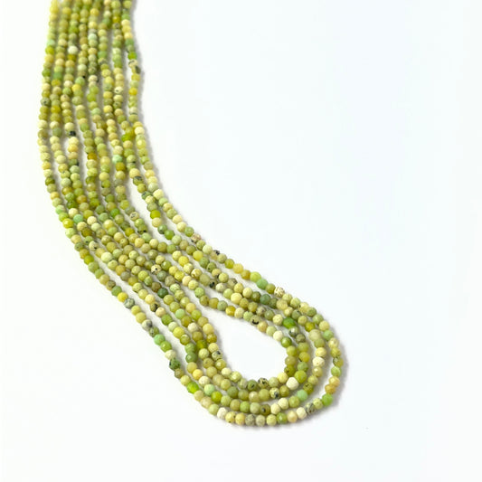 Genuine Green Opal stone beads in faceted rondelle cut, showcasing soft green tones for DIY jewellery design.