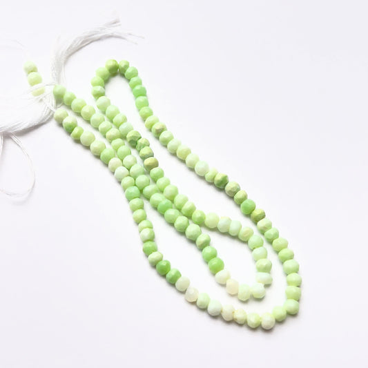 Close‑up of green opal 3.8–4mm faceted rondelle gemstone beads