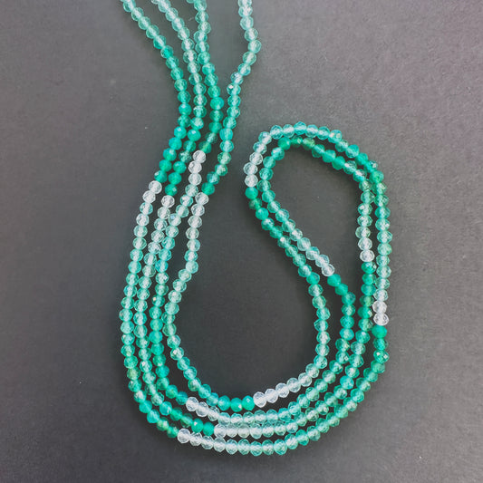 Close-up of Green Shaded Onyx faceted rondelle beads with gradient green tones and sparkling facets.