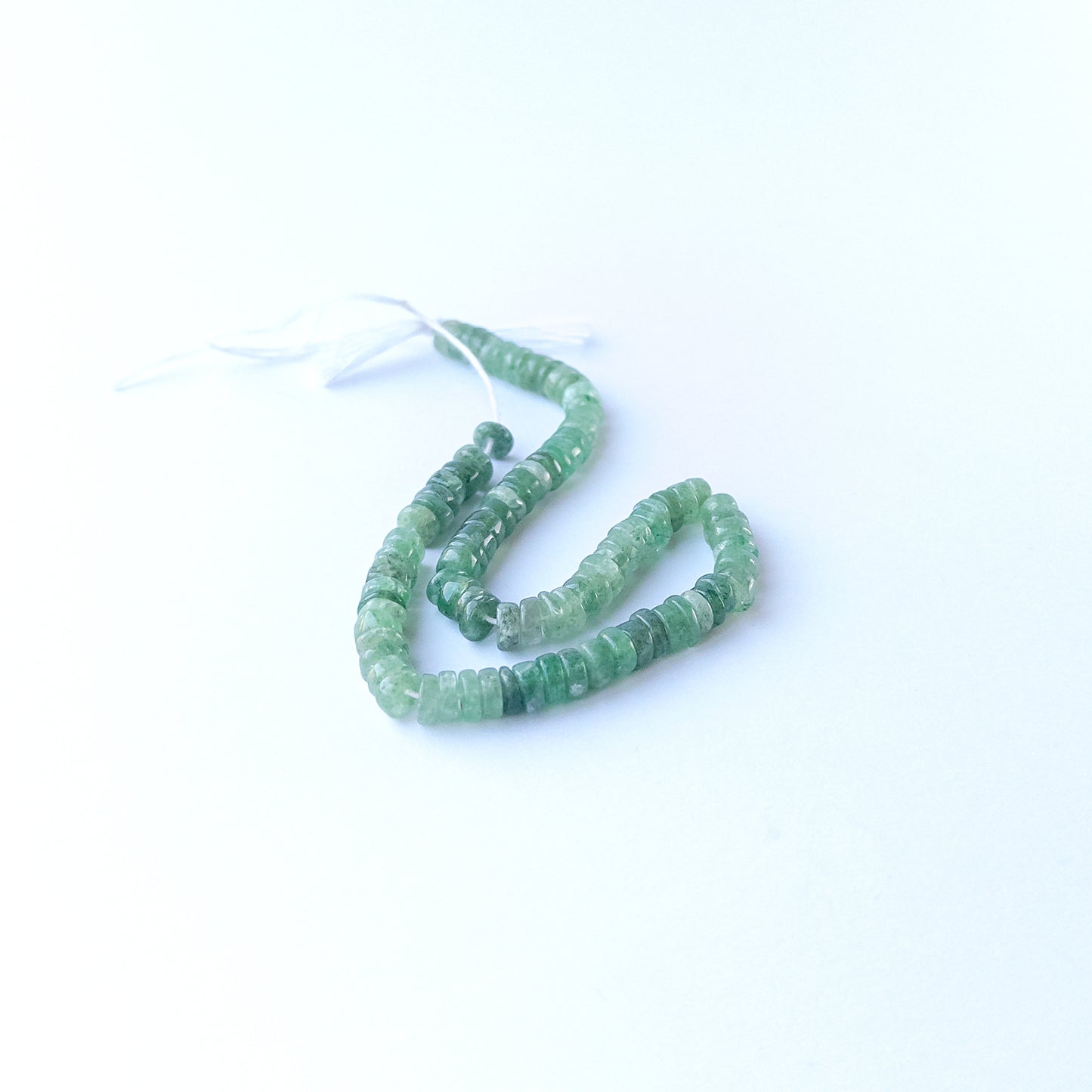 Genuine Green Strawberry Quartz stone beads showcasing polished wheel cuts and subtle natural shimmer.