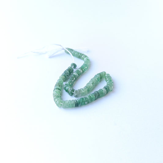 Genuine Green Strawberry Quartz stone beads showcasing polished wheel cuts and subtle natural shimmer.