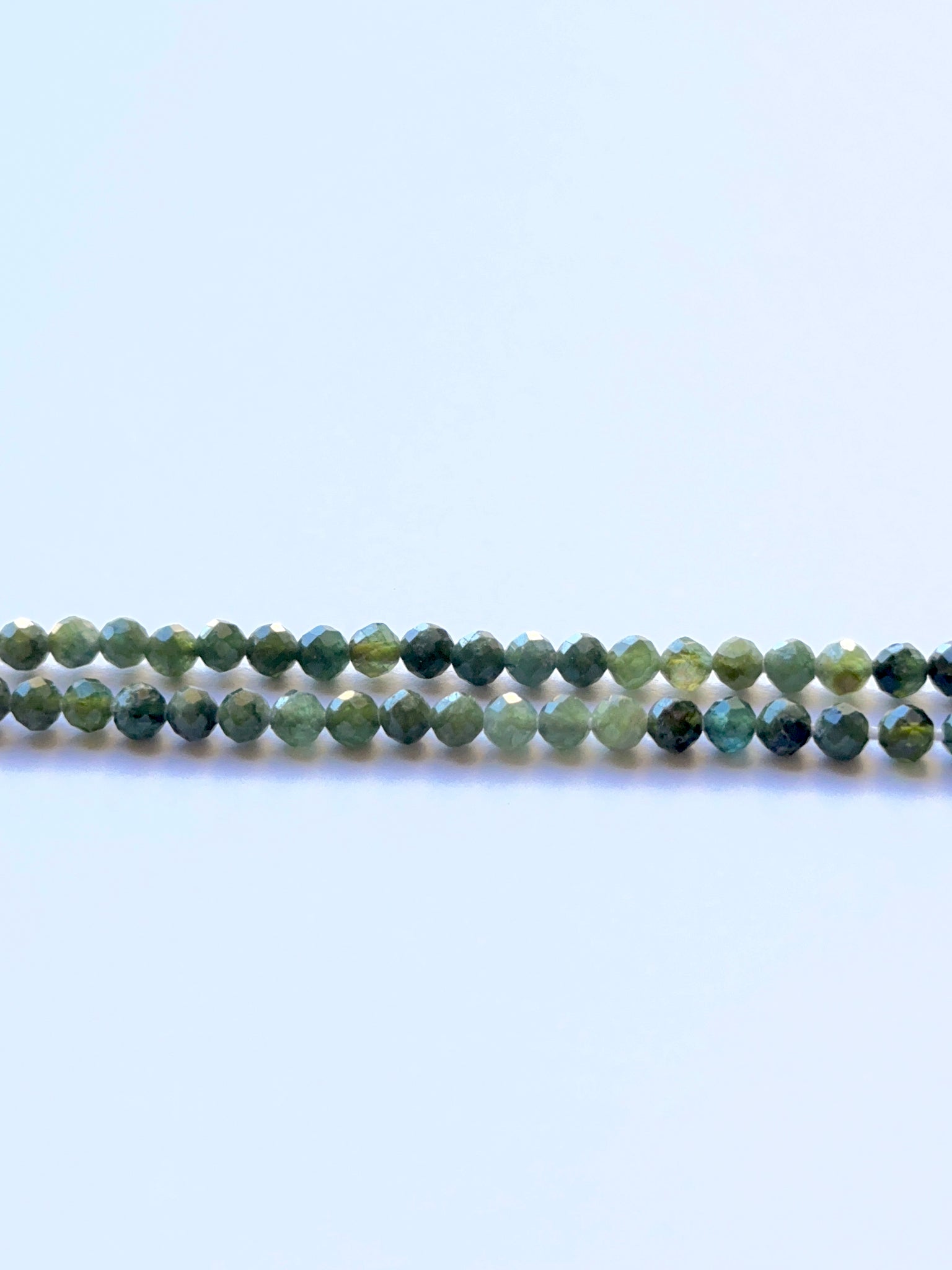 Green Tourmaline faceted sphere 3.5mm beads on a 32cm strand showing vivid green sparkle for jewellery making.
