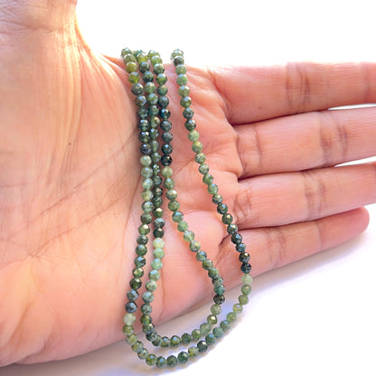 Tiny green tourmaline 3.5mm faceted spheres on a 32cm strand displaying consistent size and vibrant emerald hues for designers.