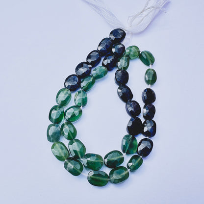 Green Tourmaline faceted rondelle beads with deep green tones arranged on a 29cm strand for jewellery making.