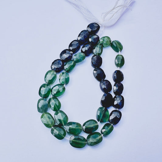 Green Tourmaline faceted rondelle beads with deep green tones arranged on a 29cm strand for jewellery making.