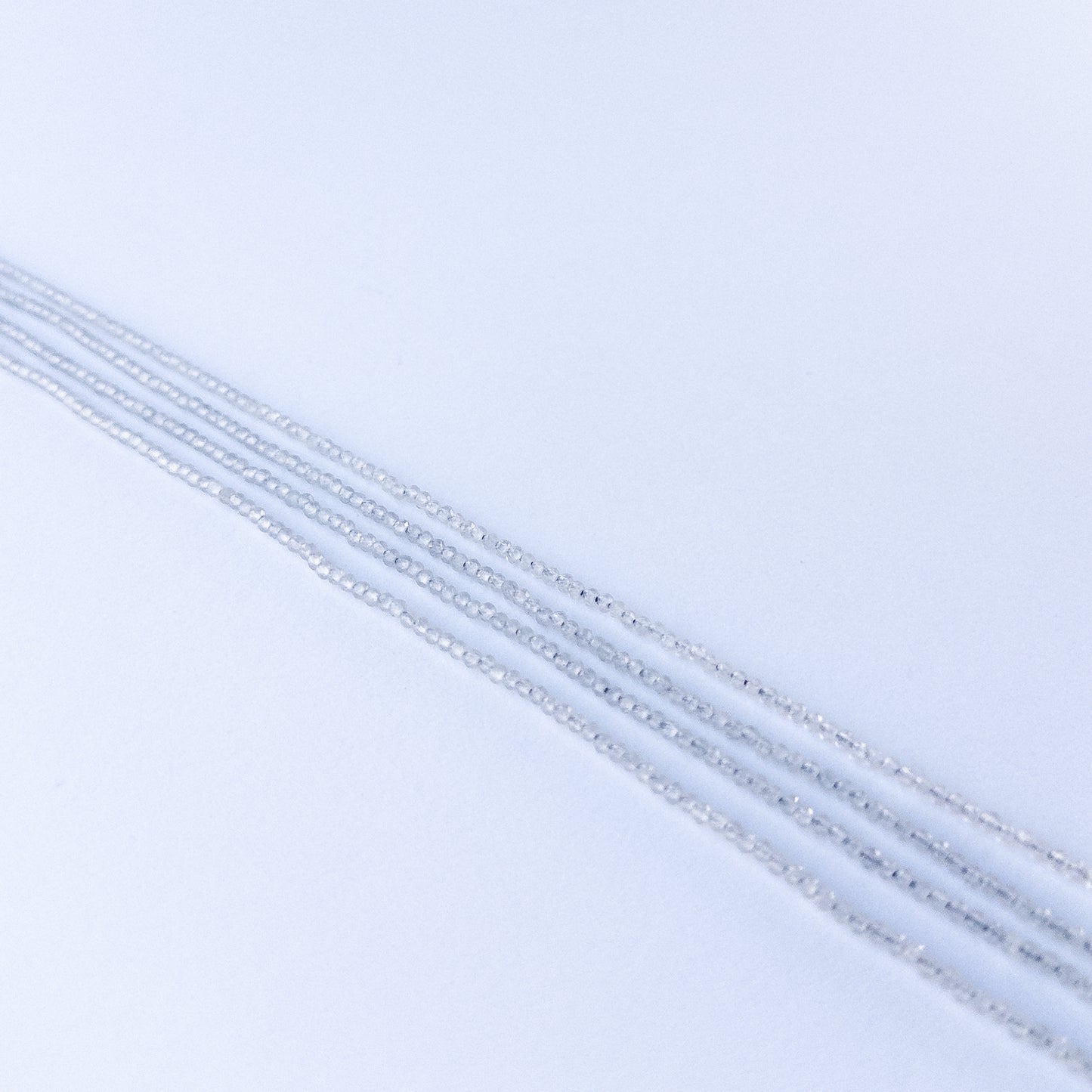 Soft grey Chalcedony faceted rondelle stone beads 2.2mm displayed neatly for DIY jewellery and authentic gemstone designs.