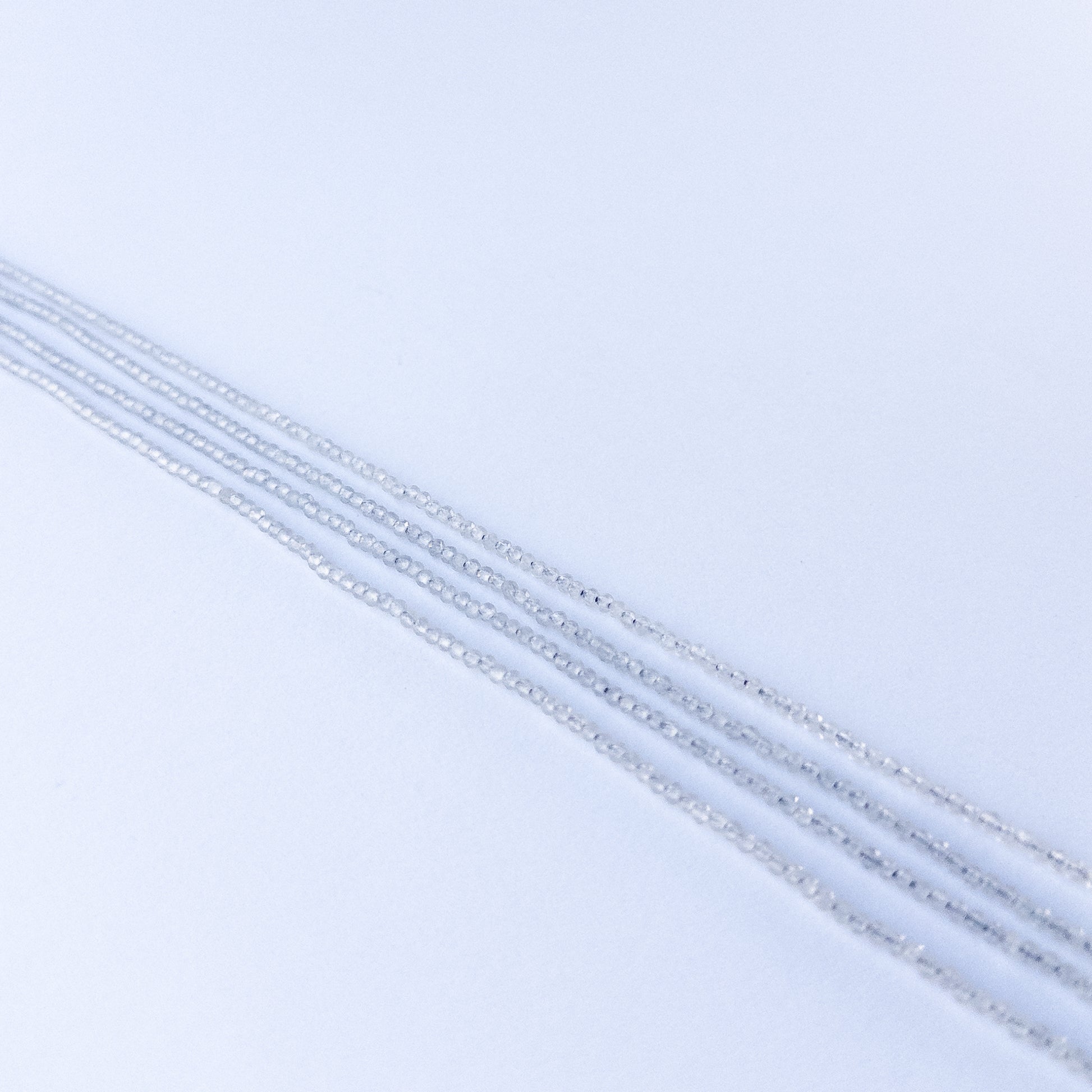 Soft grey Chalcedony faceted rondelle stone beads 2.2mm displayed neatly for DIY jewellery and authentic gemstone designs.