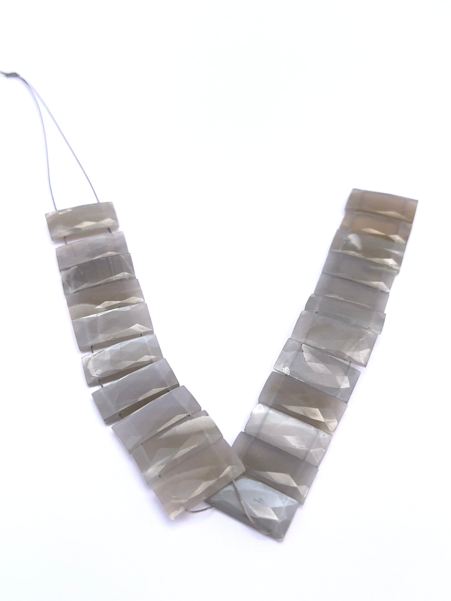 Natural Grey Moonstone stone beads arranged in strands with elegant sparkle.