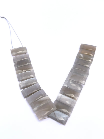 Natural Grey Moonstone stone beads arranged in strands with elegant sparkle.