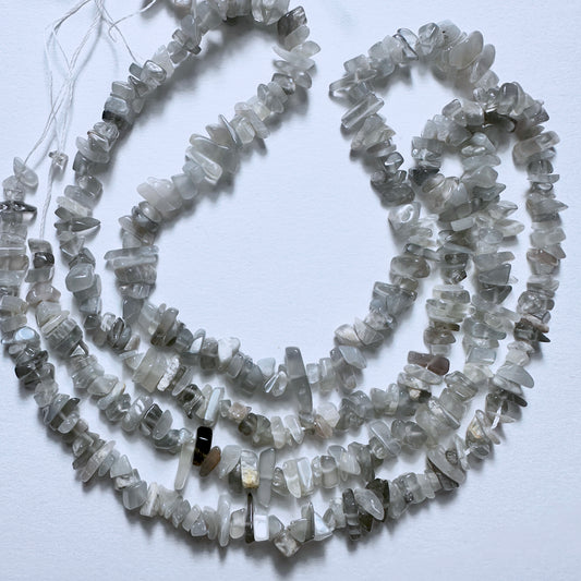 Grey Moonstone chips with soft grey hues and polished finish, arranged on a 44cm strand of natural gemstone beads.