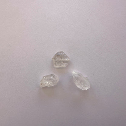Detailed view of Herkimer undrilled stones with luminous clarity and raw texture