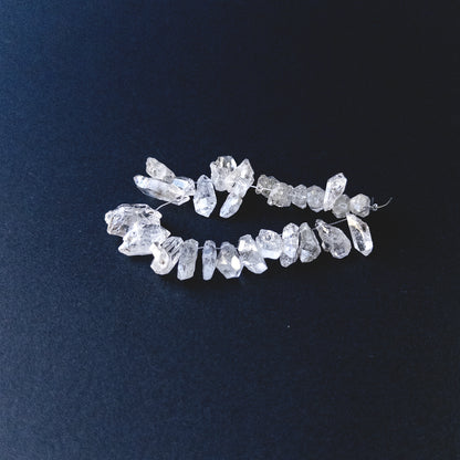 Close‑up of Herkimer Diamond drilled rough gemstone beads highlighting clarity, texture and natural sparkle.
