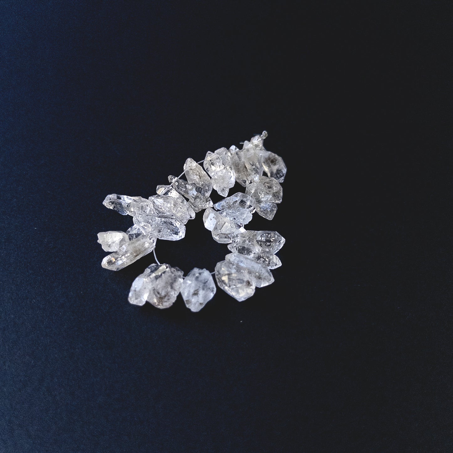 Handmade jewellery components featuring Herkimer Diamond rough beads with bright reflective surfaces.