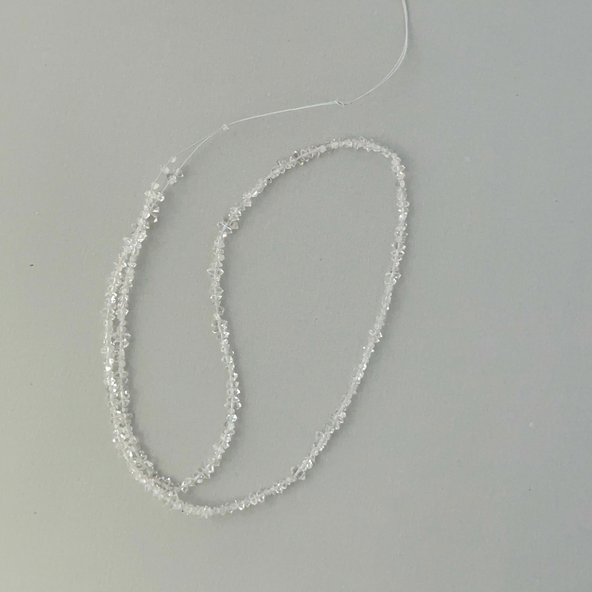 Macro detail of Herkimer Diamond quartz chip beads showing water-clear clarity for jewellery making