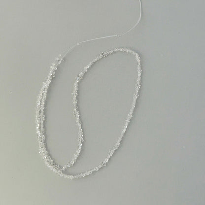 Macro detail of Herkimer Diamond quartz chip beads showing water-clear clarity for jewellery making