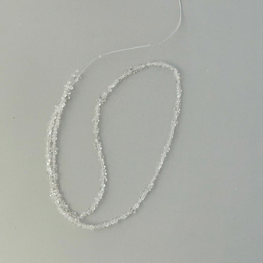 Macro detail of Herkimer Diamond quartz chip beads showing water-clear clarity for jewellery making