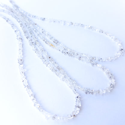 Close‑up of genuine Herkimer Diamond chip beads highlighting their clarity, sparkle and natural crystal form.