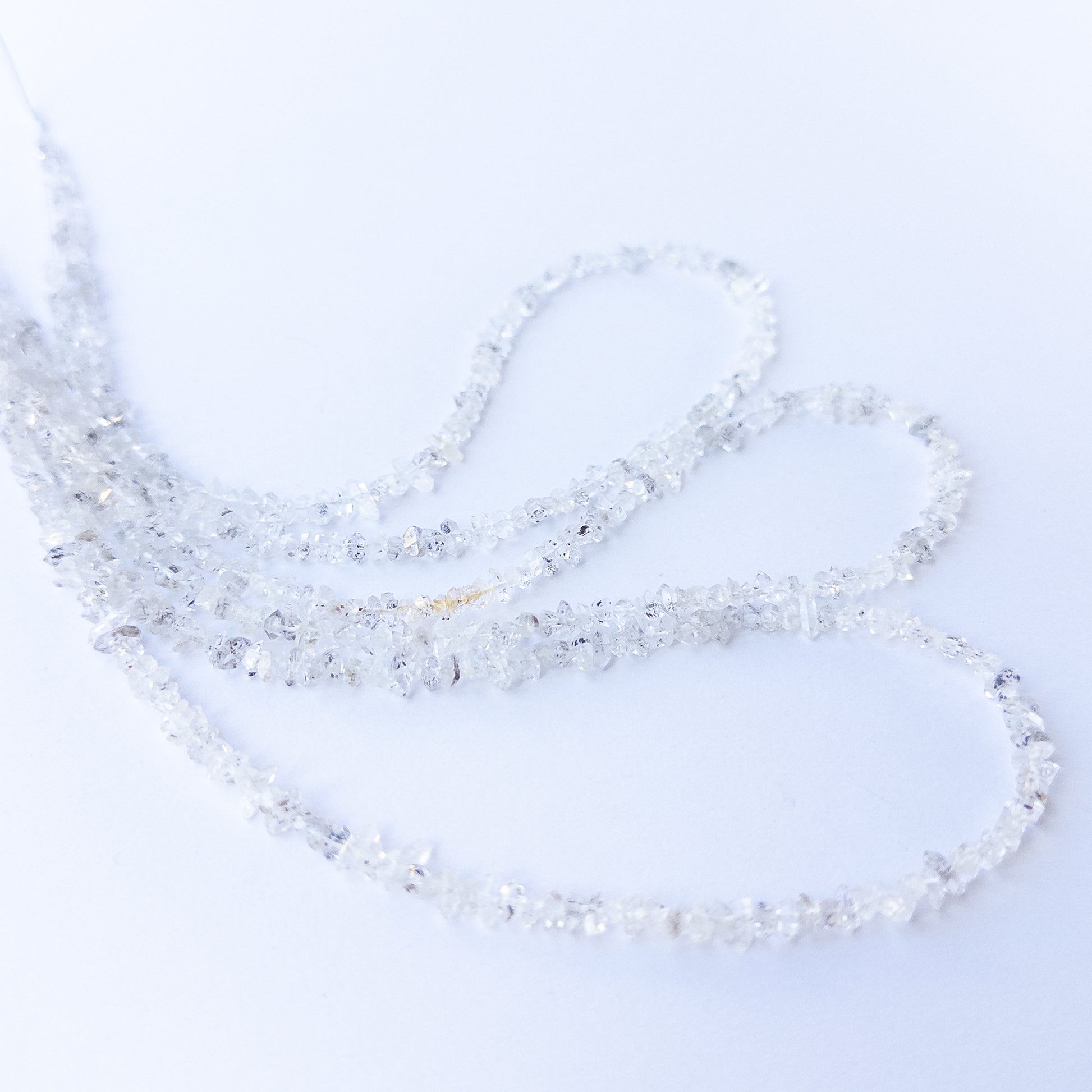 Handmade jewellery components featuring authentic Herkimer Diamond chip beads with bright reflective shine.
