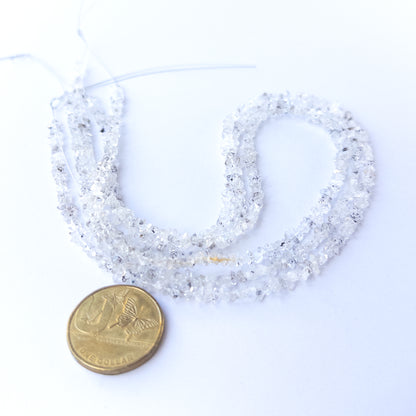 A dial gauge measures the Herkimer Diamond chip‑cut 3–4mm gemstone.