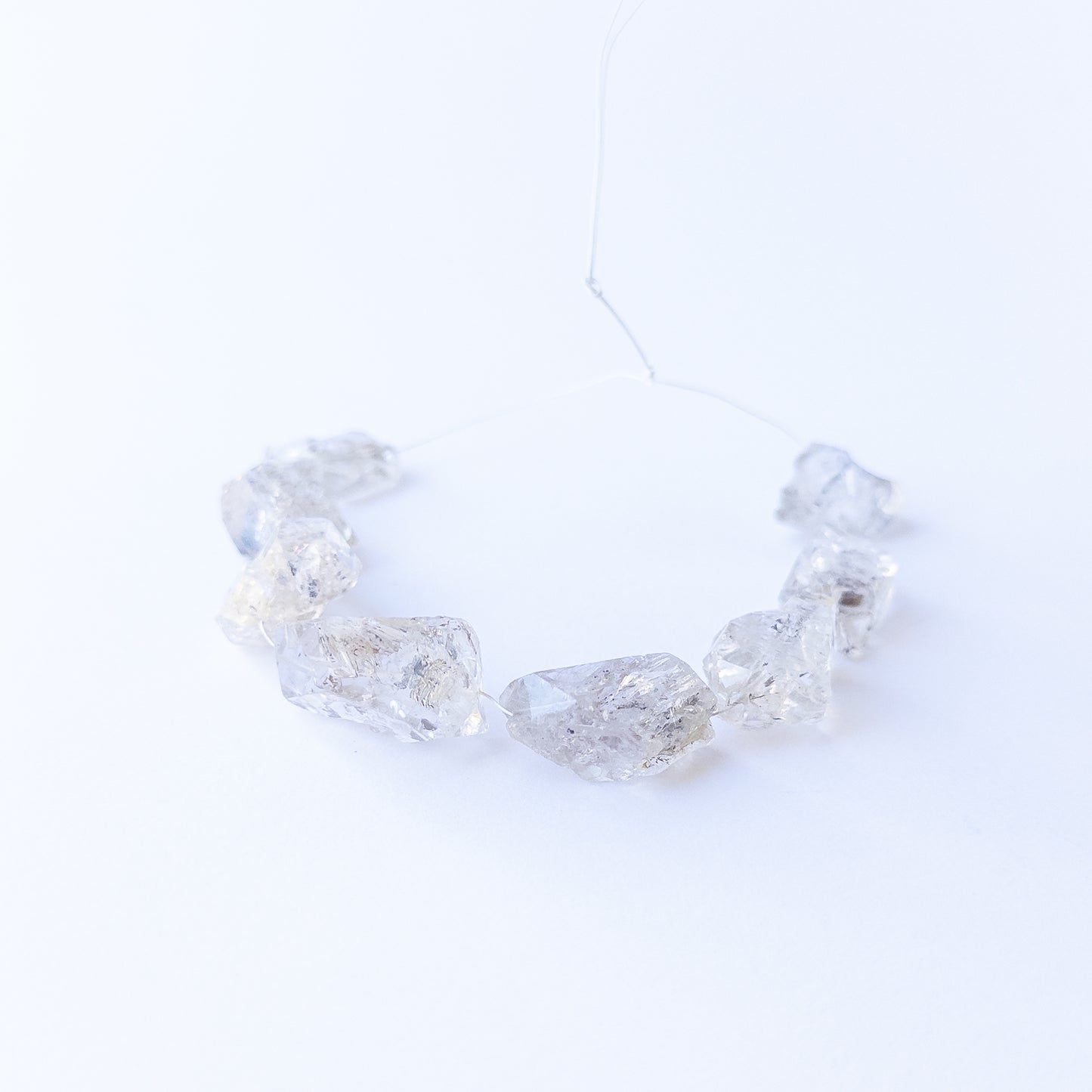 Authentic Herkimer Diamond rough stone beads arranged to highlight their angular crystal form.
