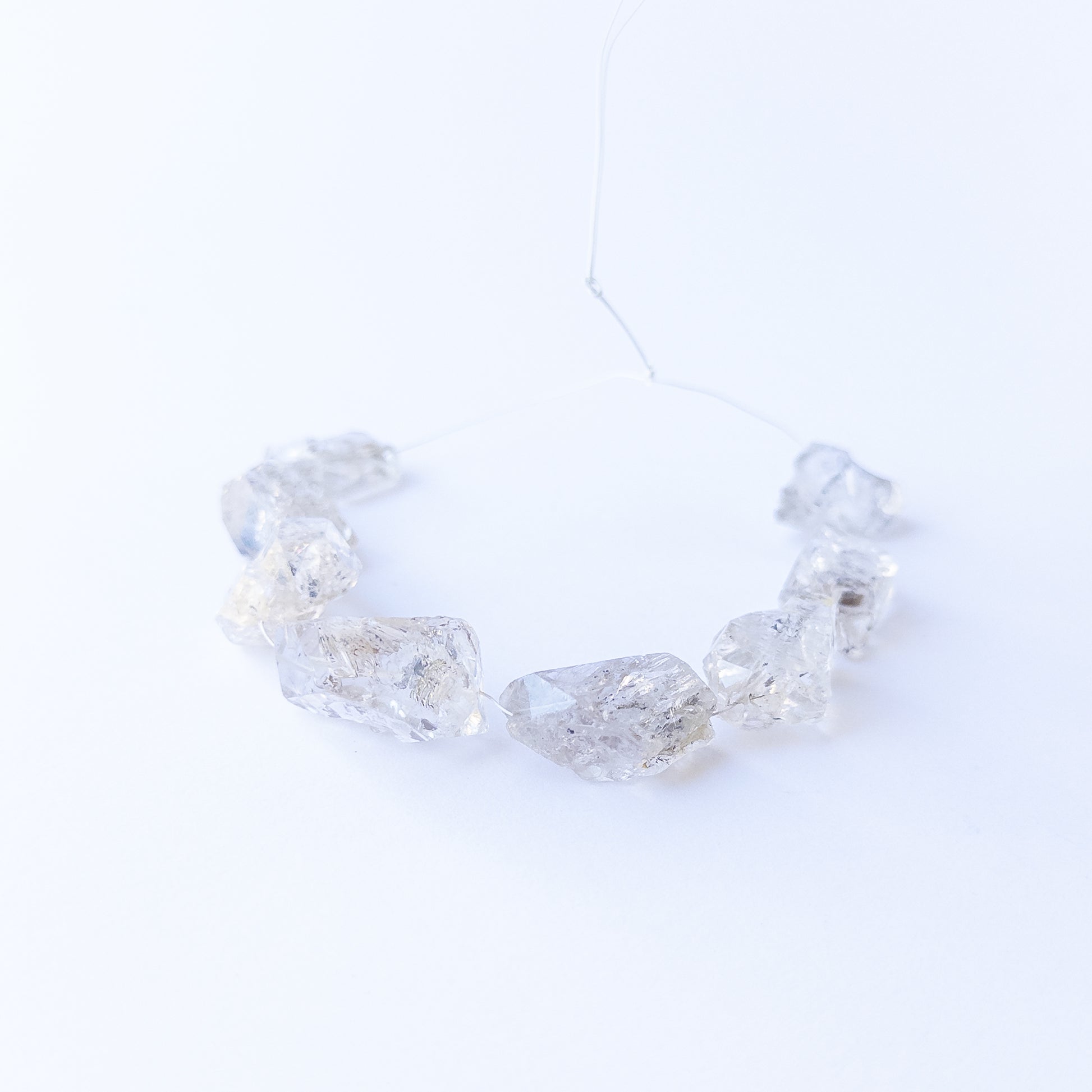Authentic Herkimer Diamond rough stone beads arranged to highlight their angular crystal form.